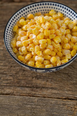 frozen sweet corn on woode surface