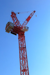 Tower crane against blue sky, UK.
