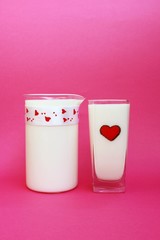 A Jug and glass of milk on pink background, Milk concept