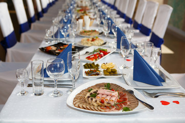 Served with Cutlery to table. A Banquet with food and snacks with a luxurious setting on a white tablecloth.