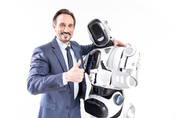 Happy smiling male person embracing cyborg