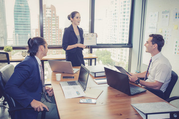 businesswoman presentation to a group in meeting.