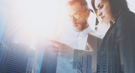 Group of businessmans on meeting.Business team in working process.Double exposure,skyscraper...