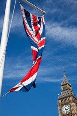 Fototapeta na wymiar england flags in the wind in front of Big Ben, London, UK