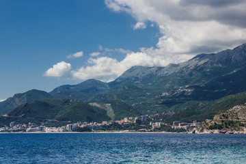 Obraz premium Montenegro sea shore with mountains and blue cloudy sky landscape.