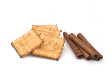 Crackers and cinnamon sticks on a white background
