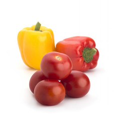 Red tomatoes and colored peppers on a white background