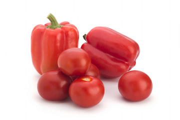 Red tomatoes and pepper on a white background