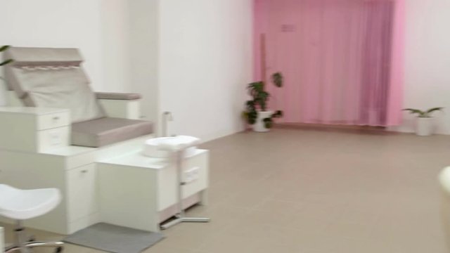 Interior of empty modern beauty salon. Armchairs for manicure and pedicure. White colored