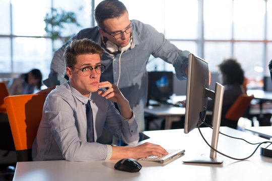 Two Business People Working With computer in office