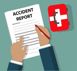 Businessman Completing Accident Report document beside First Aid Kit - Health and Safety concept
