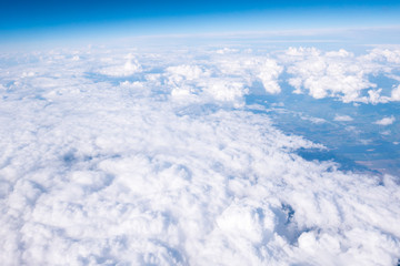 Fototapeta na wymiar Clouds and sky sunny day through airplane window