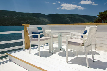 Summer restaurant empty white chair and table.