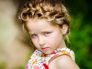 Cute little preschooler girl natural portrait on the sun