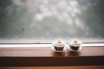 Teacup on a rainy day window background in Taiwan