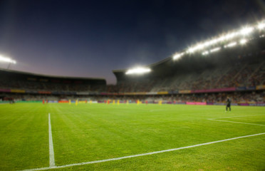 Naklejka na ściany i meble evening stadium arena soccer field defocused background
