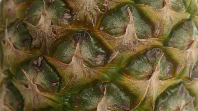 Texture of Ananas comosus slow tilt 4K 2160p 30fps UltraHD footage - Detailed pineapple fruit surface close-up 4K 3840X2160 UHD tilting video