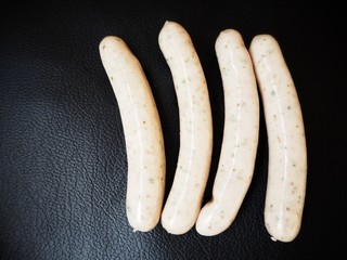 White sausage on black background