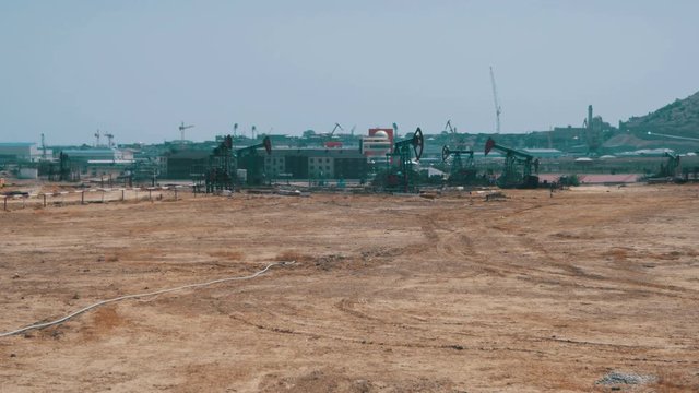 Oil Pump, Fossil Fuel Energy, Old Pumping Unit. Platform. Extraction of pumping station. Industrial oil pump jack working and pumping crude oil for fossil fuel energy with drilling rig in oil field.