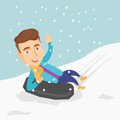 Man sledding on snow rubber tube in the mountains.