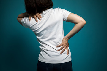 young woman having a pain in her neck and back.