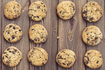 Oat cookies with chocolate drops on brown wooden background