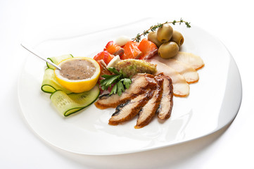 Cold fish appetizer with lemon sauce on white dish isolated on white background