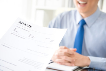 Young businessman submitting resume to employer to review