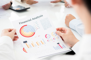 Businessman analyzing financial graph document