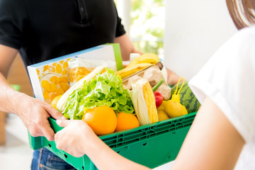 Delivery man delivering food to a woman at home