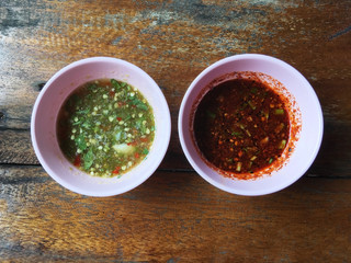 Top view of pink bowls Thai spicy sauces