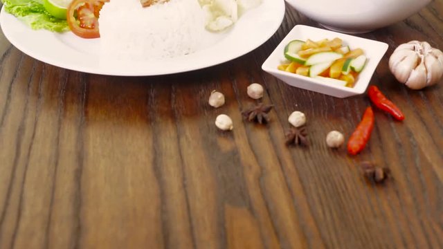 Video footage of a delicious Indonesian food Sop Buntut served with a plate of rice on the reserved table in the restaurant
