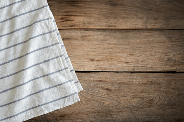 White tablecloth on wood background with copy space.
