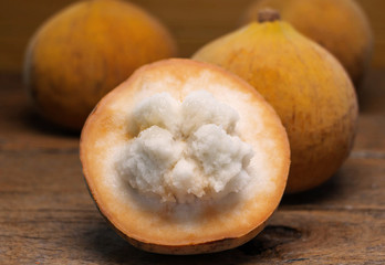 fresh cut santols on wooden board