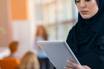 beautiful Arabian girl with tablet computer working at startup office