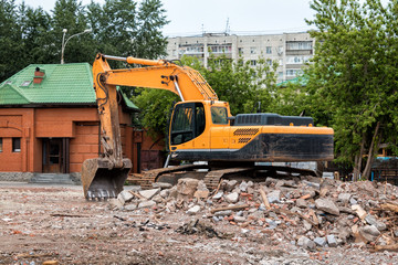 Crawler excavator at the site of the destroyed building