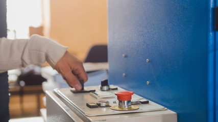 The operator controls the machine in the printing house