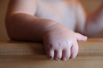 Sweet 6 month old Baby Boy's Hand on crib