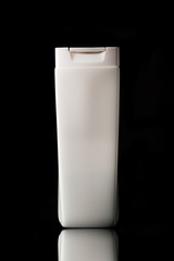 Plastic bottle of skin care isolated on black