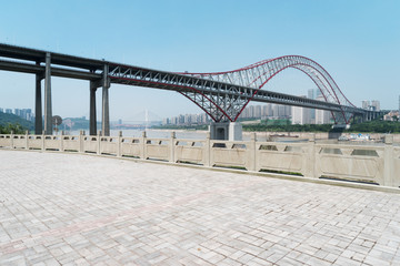 empty floor with steel bridge in modern city