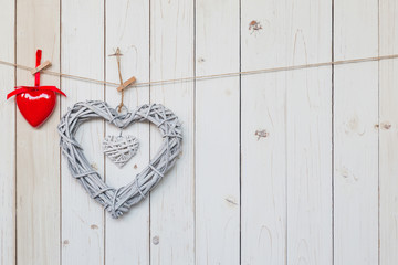 wooden rustic decorative hearts hanging on vintage wooden background with space.