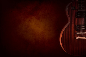 Part of the red electric guitar on black background. A place for writing of the text.