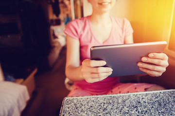 girl is typing text on the tablet computer. The concept of social mobility, the Internet, work as a freelancer.