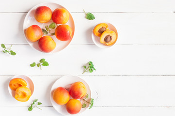 Apricot on wooden white background. Sliced apricot top view, flat lay, copy space