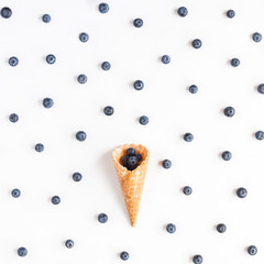 Fresh blueberry in waffle cone. Flat lay, top view