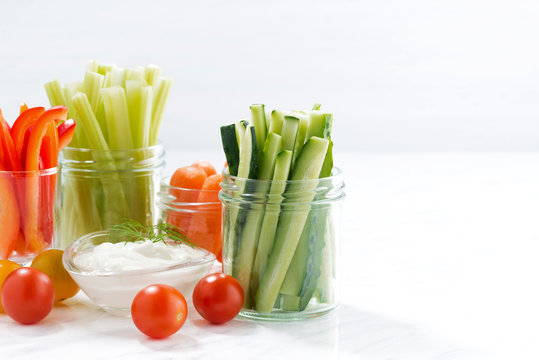 Fototapeta healthy snacks, mixed vegetables and yogurt and white background