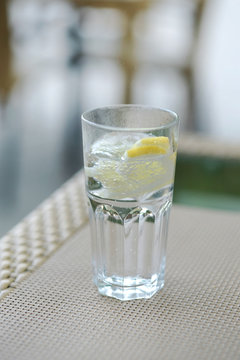 a glass of carbonated water and a lemon