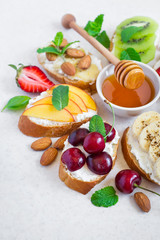 selection summer sweet snacks. Bruschetta or sandwiches with fruit and berries. Selective focus