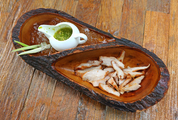 harcoal-boiled pork neck in wood plate, Grill pork (Thai style food).