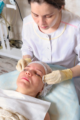 Obraz na płótnie Canvas Beautician prepares face girls cream anesthetic